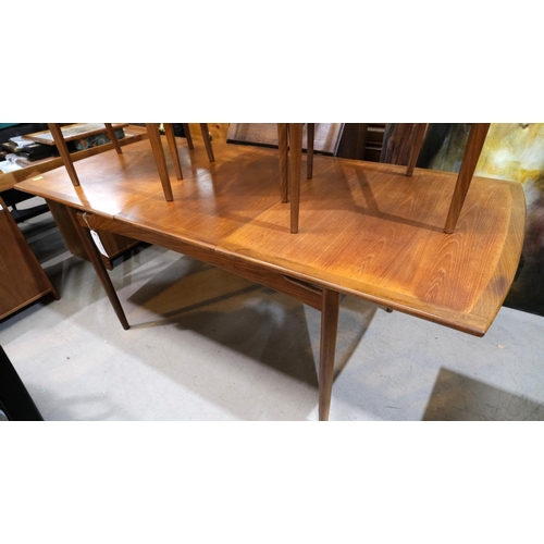 851 - A mid 20th century G-Plan 'Brasilia' teak dining suite comprising extending rounded rectangular tabl... 