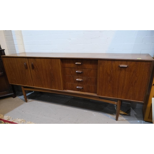 852 - A mid 20th century G-Plan 'Brasilia' teak long low sideboard with double cupboard and four drawers, ... 