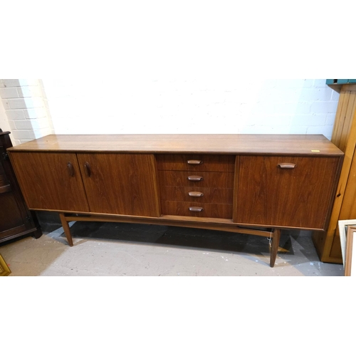 852 - A mid 20th century G-Plan 'Brasilia' teak long low sideboard with double cupboard and four drawers, ... 