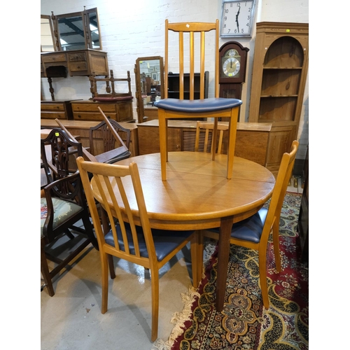 875 - A mid 20th century G Plan teak dining table with interior leaf; four teak Morris of Glasgow chairs a... 