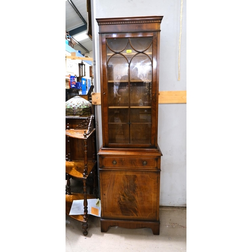 885 - A narrow reproduction mahogany full height display cabinet enclosed by glazed and one panelled door