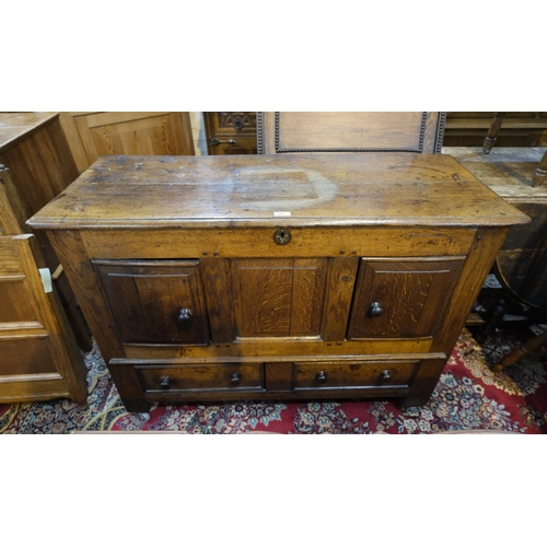 895 - An 18th century framed and panelled oak mule chest with hinged top and 2 lower drawers, the top 2 pa... 