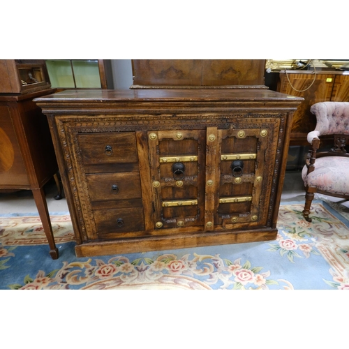 907 - An unusual Indian hardwood side cabinet with double doors with brass mounts and 3 short drawers