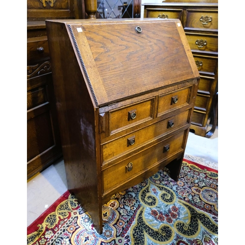 931 - A 1930's oak front bureau with two large drawers and two short drawers.