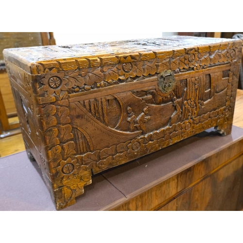 951 - An oriental camphor wood bedding box with extensive carved wood decoration, length