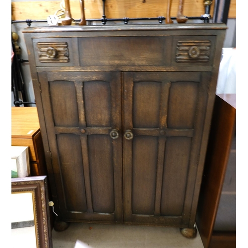 952 - An oak C.W.S tallboy with single drawer and double cupboard, and two traditional bed ends and irons