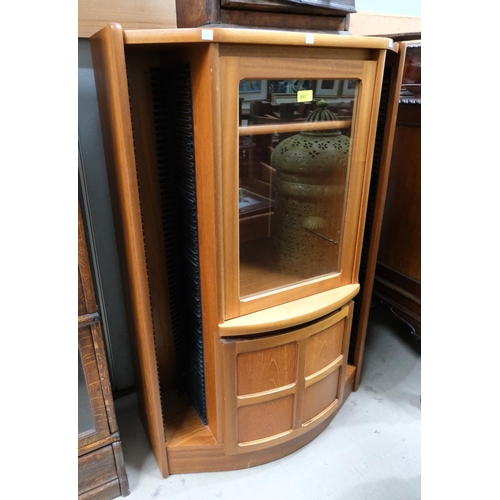 957 - A Nathan teak cupboard with glazed cupboard over second cupboard with typical cross panel door, flan... 