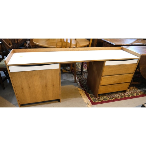 976 - A mid 20th century unusual teak desk with cupboard to one pedestal and drawers to the other with whi... 