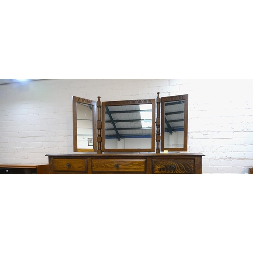 980 - A golden oak dressing table with triple mirror and five drawers below and a dressing stool, 144 x 50... 