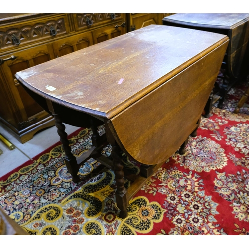 987 - An oak drop leaf barley twist table, length 106cm