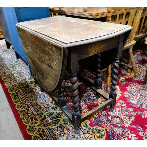 988 - An oak drop leaf barley twist table, length 106cm and 2 dining chairs