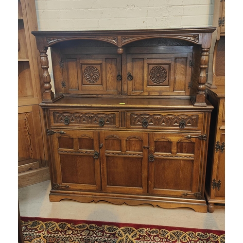 853 - A reproduction golden oak carved buffet sideboard with double cupboard above and below and two drawe... 