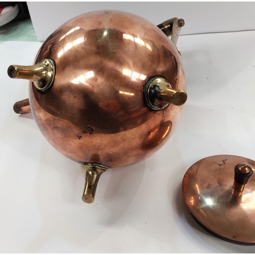 29 - CHRISTOPHER DRESSER, a copper and brass kettle of spherical form with hardwood handle, with orb back... 