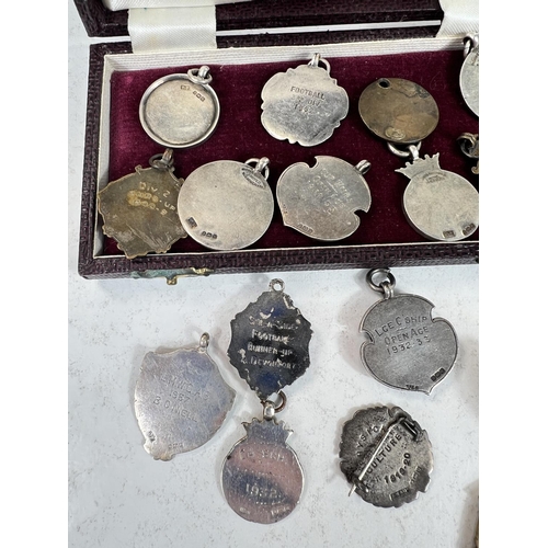 756 - A large quantity of silver and other fob medallions some with enamel some for football etc 