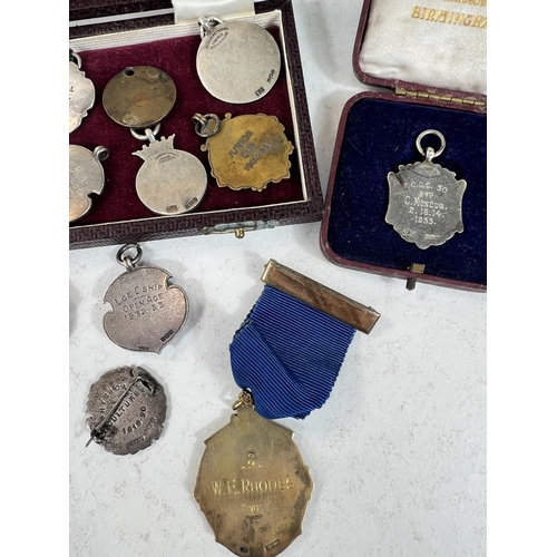 756 - A large quantity of silver and other fob medallions some with enamel some for football etc 