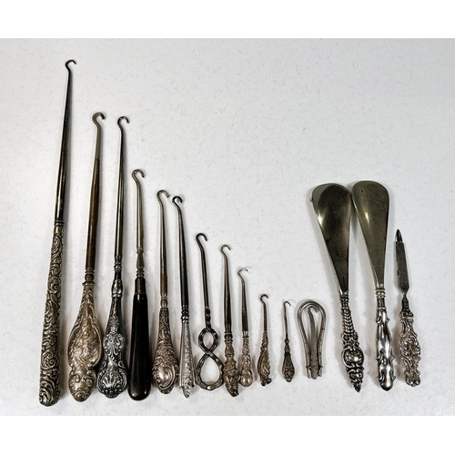 761 - A collection of silver handled button hooks and similar items