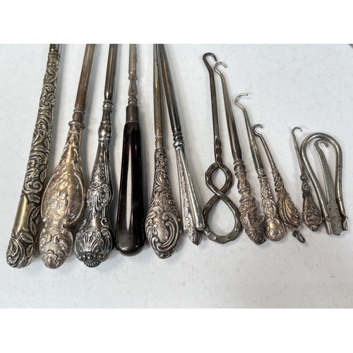 761 - A collection of silver handled button hooks and similar items