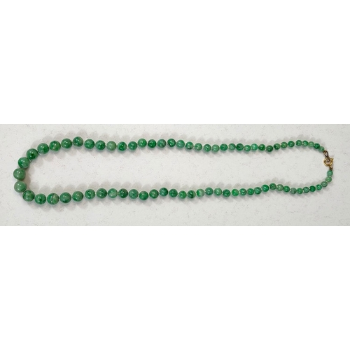 672 - GREEN JADE BEADS, a string of graduated beads, c. 1920, 50cm