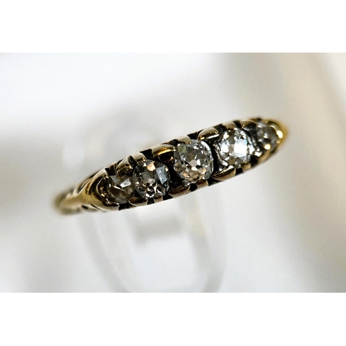 681 - A Victorian child size ring with unmarked yellow metal shank with 5 old cut diamonds in ornate split... 