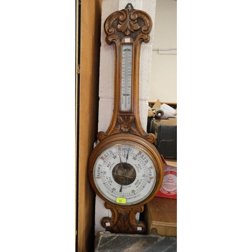 33 - A carved oak aneroid barometer by Schierwater & LLoyd Liverpool (glass a.f)