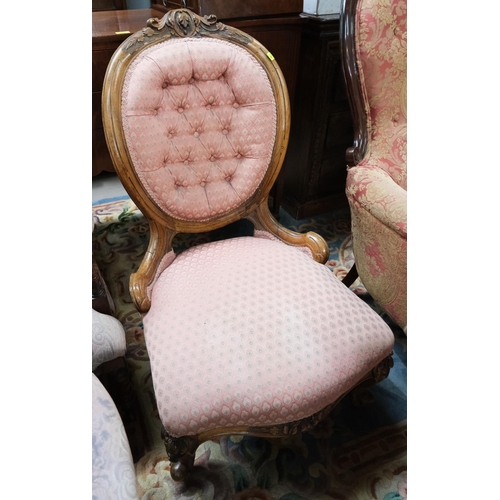 867 - A Victorian walnut framed spoon back nursing chair with button back knurled legs with carved detail ... 