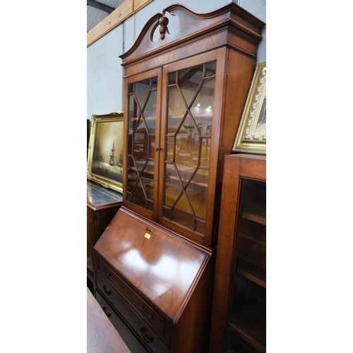 882 - A reproduction figured mahogany bureau/bookcase with 2 glazed drawers over fall front and four drawe... 