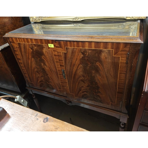 891 - A reproduction inlaid figured mahogany drinks cabinet enclosed by two doors