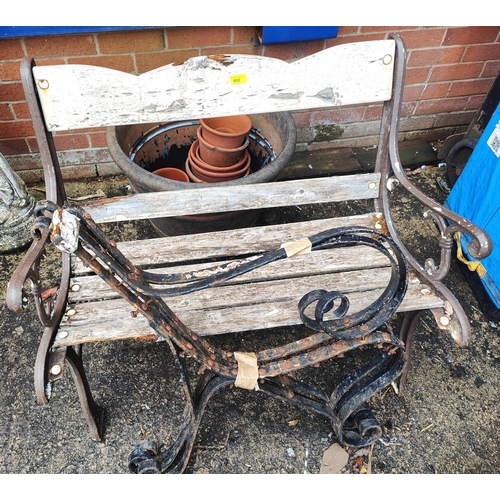 992 - A small garden bench with cast metal ends and a set of three cast iron metal bench supports