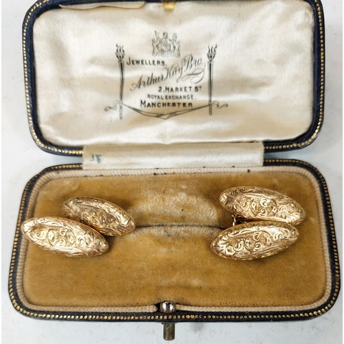 708 - A set of 9ct gold cufflinks with scrolling embossed decoration, 5.4gms