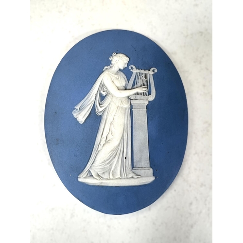 643 - An 18/19th century Wedgwood powder blue Jasper ware plaque of robed female playing the harp on colum... 