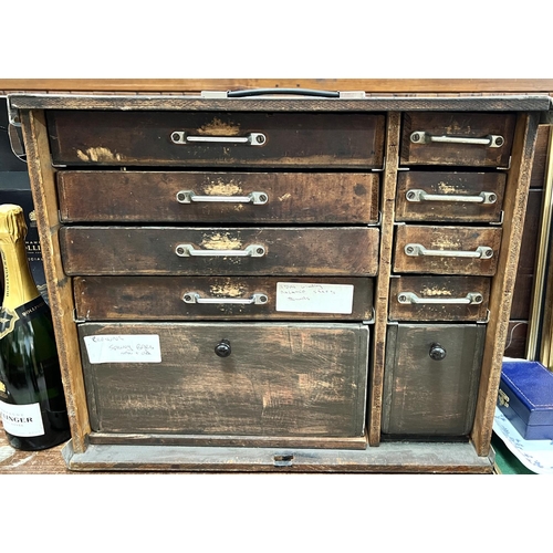 668 - A watch makers cabinet with a wide assortment of watches and watch parts