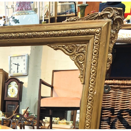 996 - A large late 19th/ early 20th century gilt framed overmantel mirror and a mahogany occasional table ... 