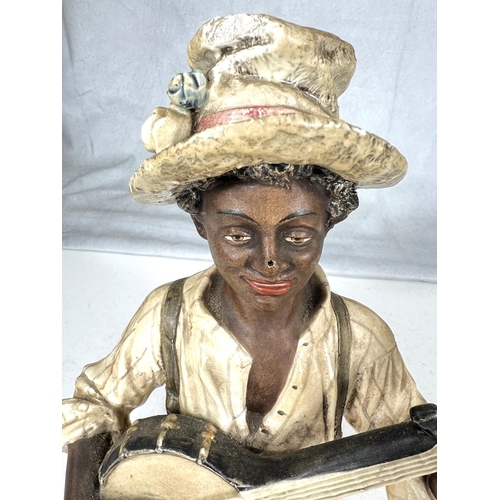 643A - A porcelain bust by Goldscheider of a man playing the banjo, height 21cm