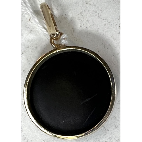 691A - A Chanel style pendant with yellow metal surround, black with clear stone 