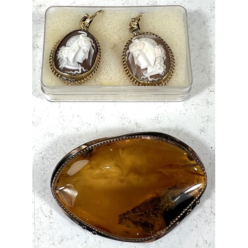 694 - A pair of female head cameo earrings; a Tara Dublin amber brooch