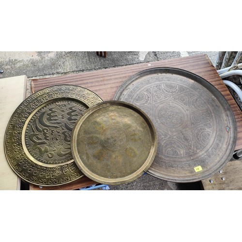 118 - An Islamic/Persian brass wall plaque with text and oval portrait of leaders, signature to the revers... 