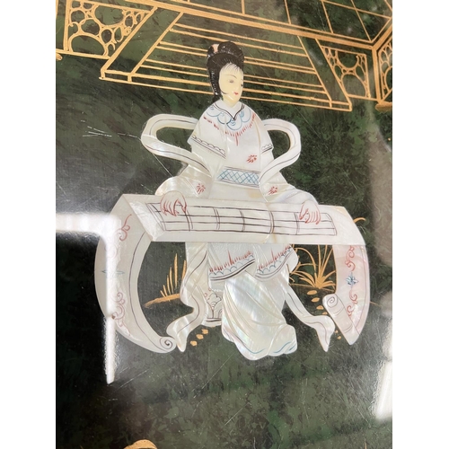 1014 - A Chinese green lacquer coffee table with dancing ladies on the top 