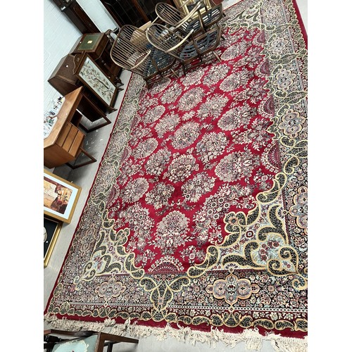 881 - A red ground Persian design wool carpet square 