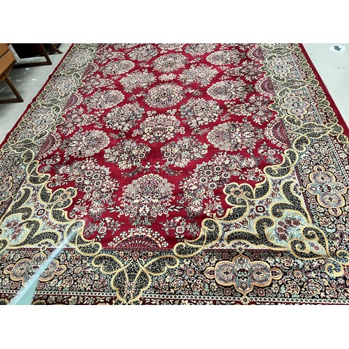 881 - A red ground Persian design wool carpet square 