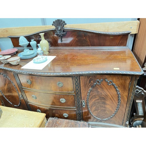 1007 - A mahogany Queen Anne style sideboard with double cupboard and three central drawers on ball and cla... 