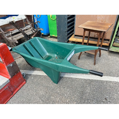 128A - A modern green plaastic wheelbarrow