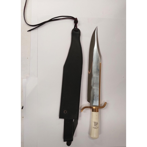 211 - A very large Hibben Knives Bowie knife with polished blade, white composition handle, with brass fit... 