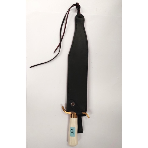 211 - A very large Hibben Knives Bowie knife with polished blade, white composition handle, with brass fit... 