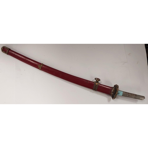 226 - A SAMURAI style sword with watered steel blade, the scabbard with red lacquer finish and metal mount... 