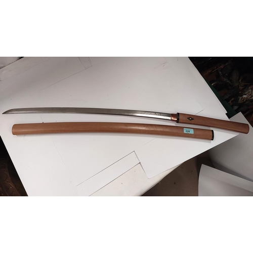 228 - A JAPANESE sword with watered steel blade, inscribed marks to the tang, in plain wood scabbard, blad... 