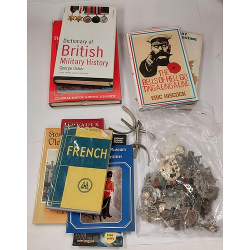 252 - A collection of military badges and buttons, a pair of spurs and a collection of books on badge coll... 