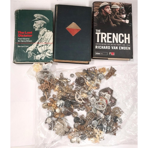 256 - A large collection of various military badges and buttons etc with small selection of hardback books