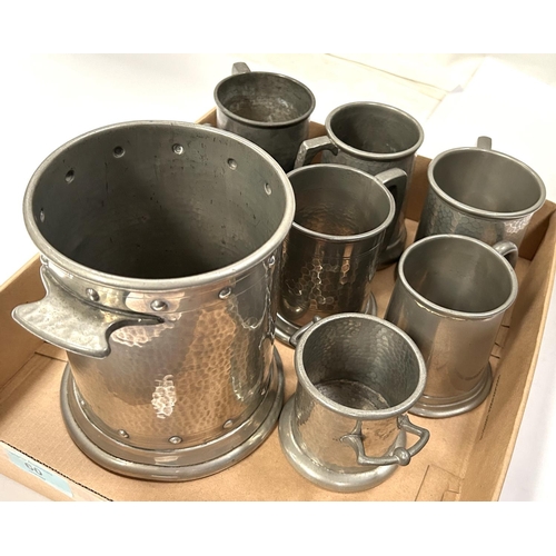 60 - A planished pewter siphon/bottle stand and 6 small pewter tankards, 3 with glass bottoms.