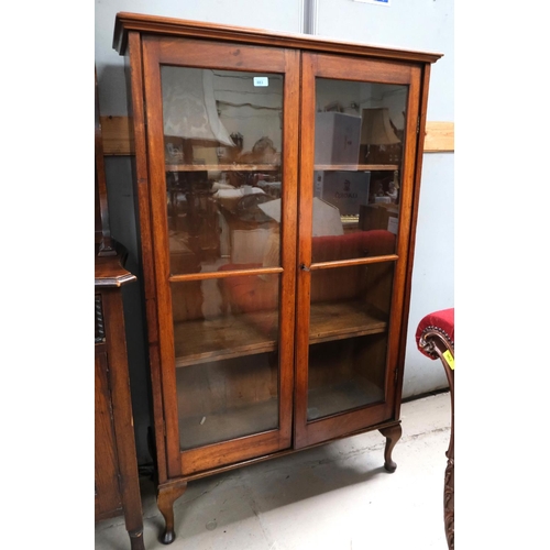 883 - A mahogany two door display cabinet on cabriole legs.