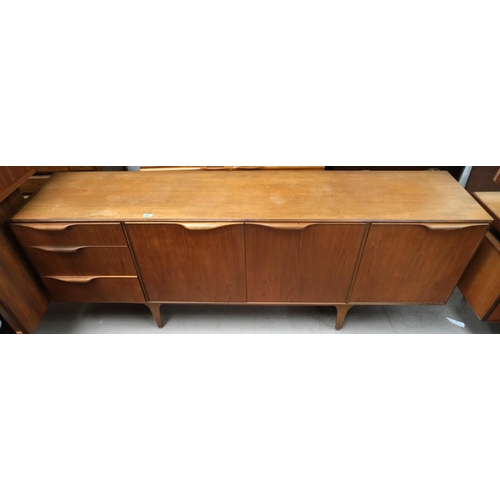 889 - A mid 20th century long low Mcintosh Dunvegan teak sideboard with three drawers, two central cupboar... 